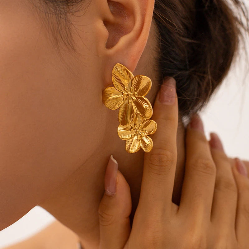 Gold Drop Double Flower Earrings on woman's ear