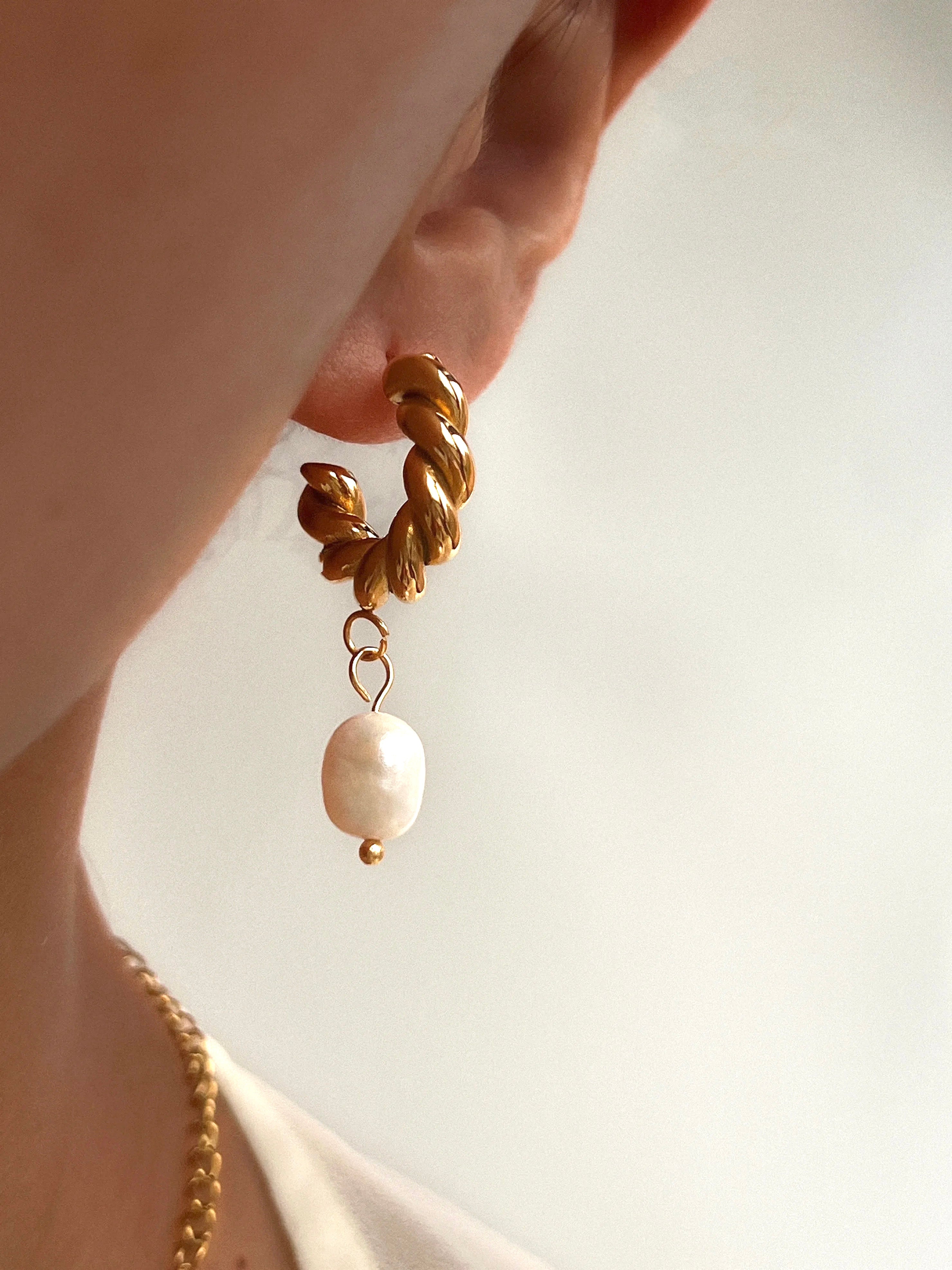 The Ever So Sexy Arc Peal and Gold Earrings modeled on woman