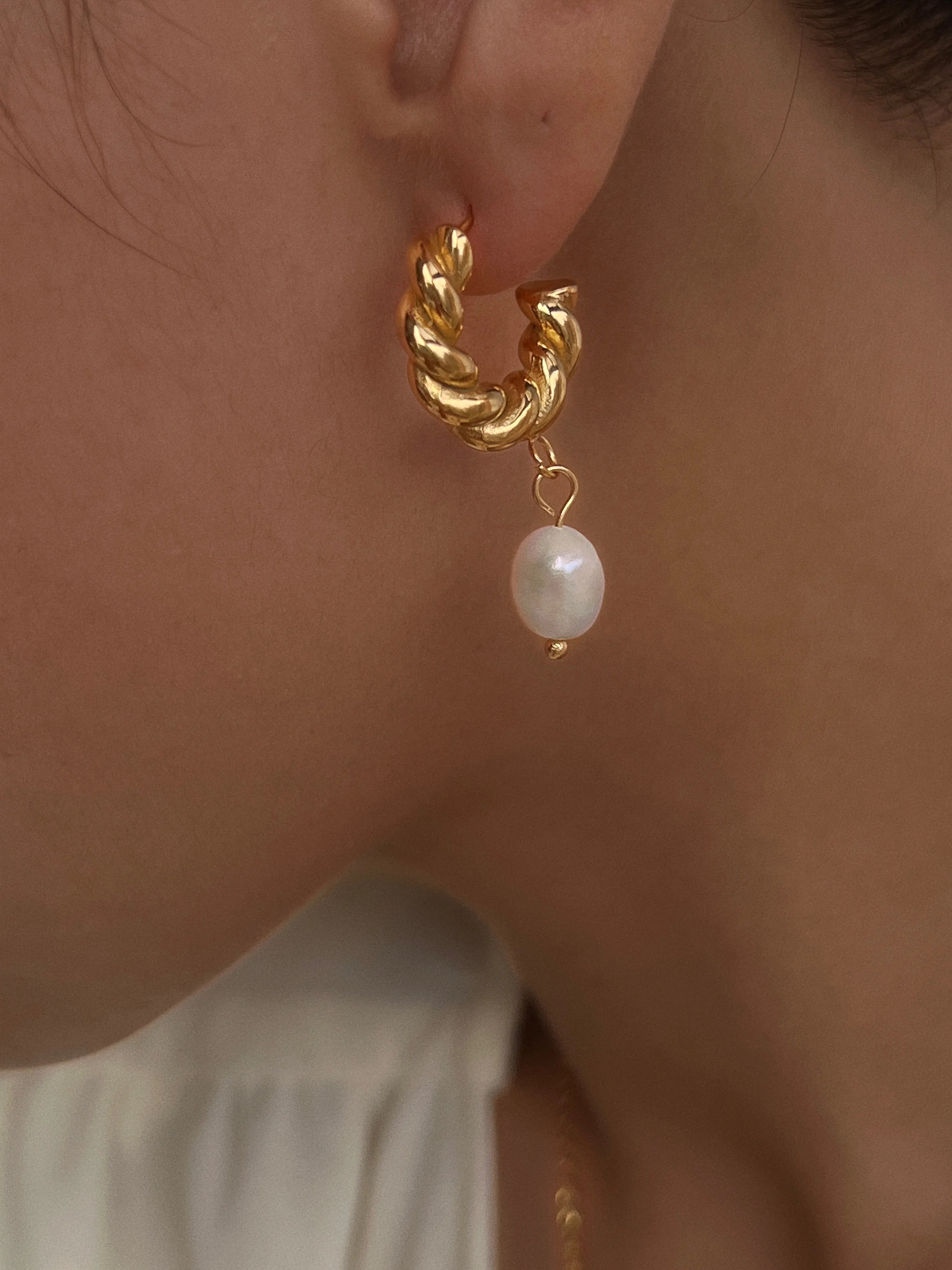 The Ever So Sexy Arc Peal and Gold Earrings modeled on woman