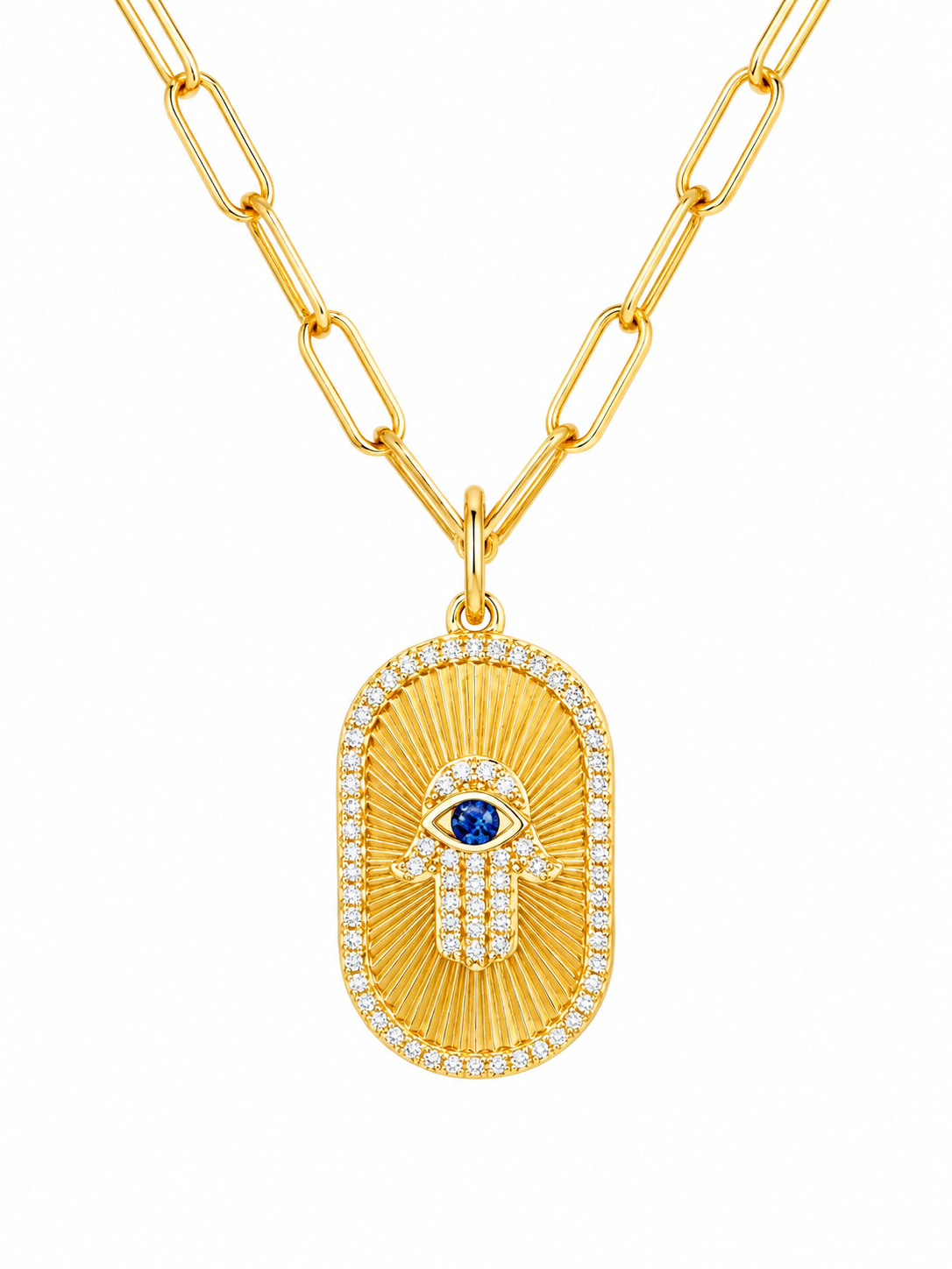 A gold paperclip chain necklace featuring an oval Hamsa pendant with a blue sapphire eye and diamond accents, set against a plain white background.