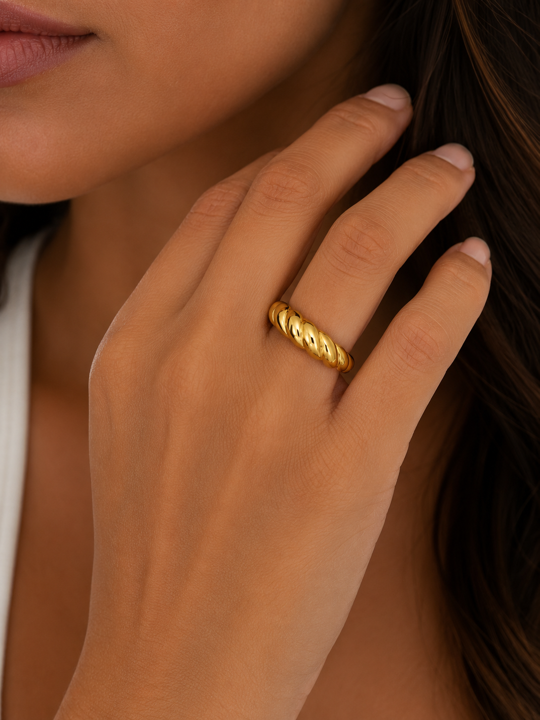 Model wearing the Colette gold croissant ring with a twisted textured design