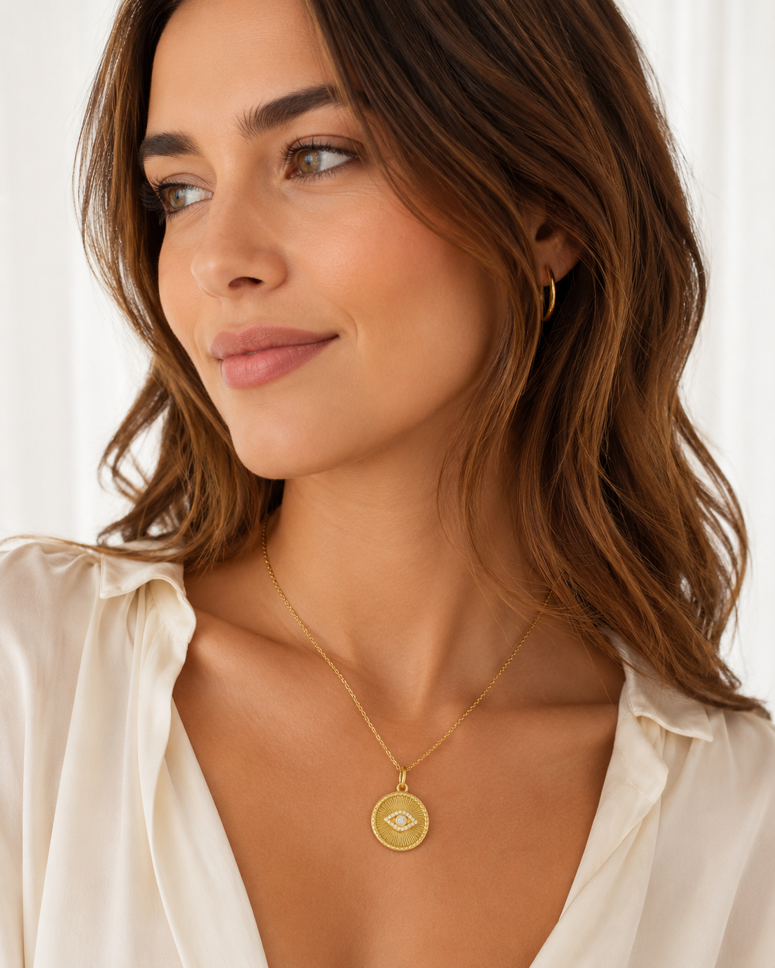 Model wearing the Karla gold evil eye pendant necklace