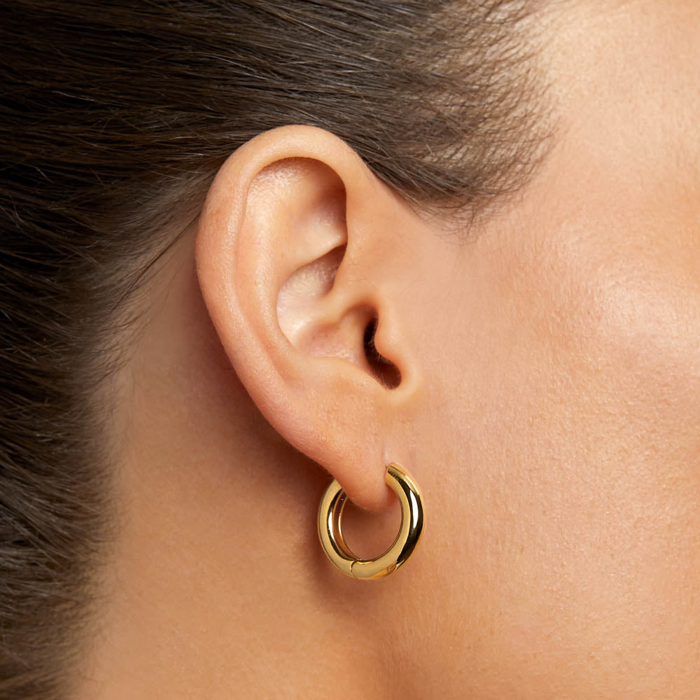 Close-up of a model wearing The Margot Everyday Hoops in polished gold