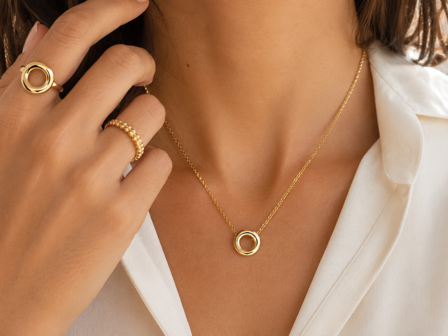 Model wearing The Sofia Open Circle Ring in gold