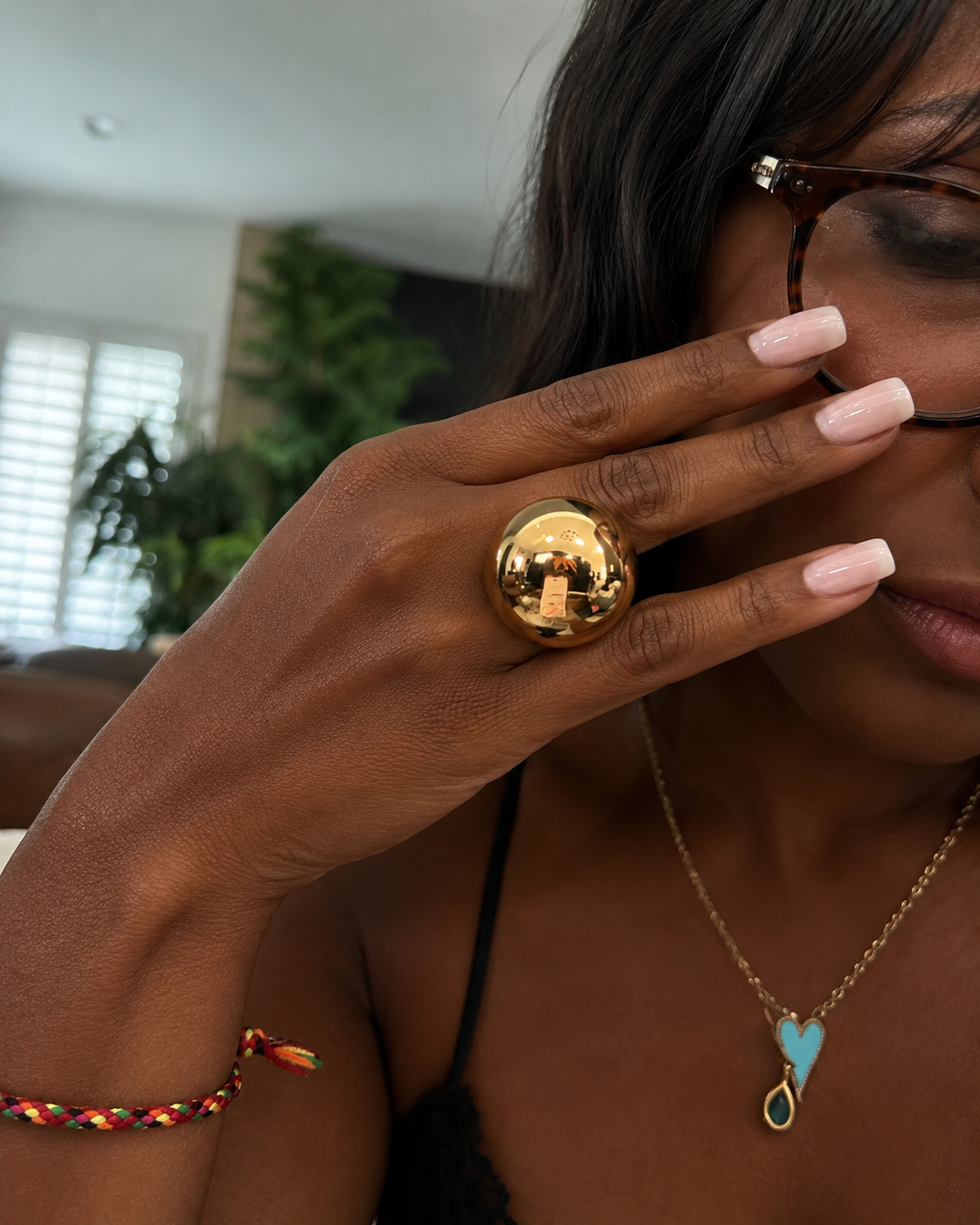 Elisa Dome Ring. Woman wearing the Elisa Dome Ring in polished gold.