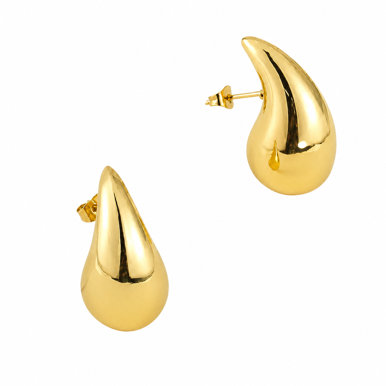 Pair of Terry gold teardrop statement earrings with a polished finish on a white background